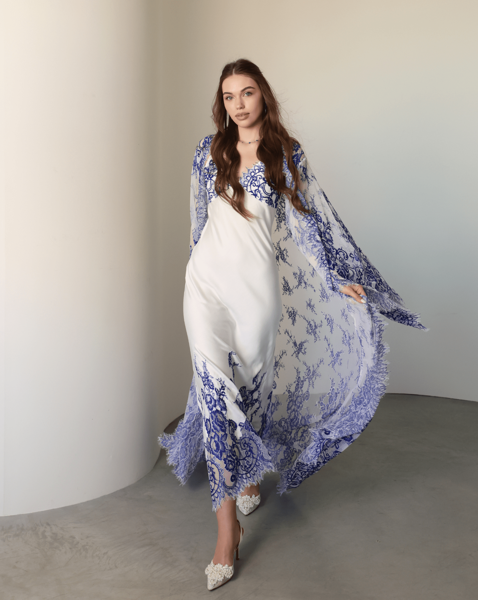 A dynamic view of the long lace train moving gracefully behind as the person walks through the room.