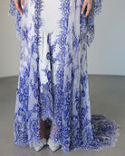 A detailed frontal view of the hem, focusing on how the intricate lace beautifully edges the gown and the robe.