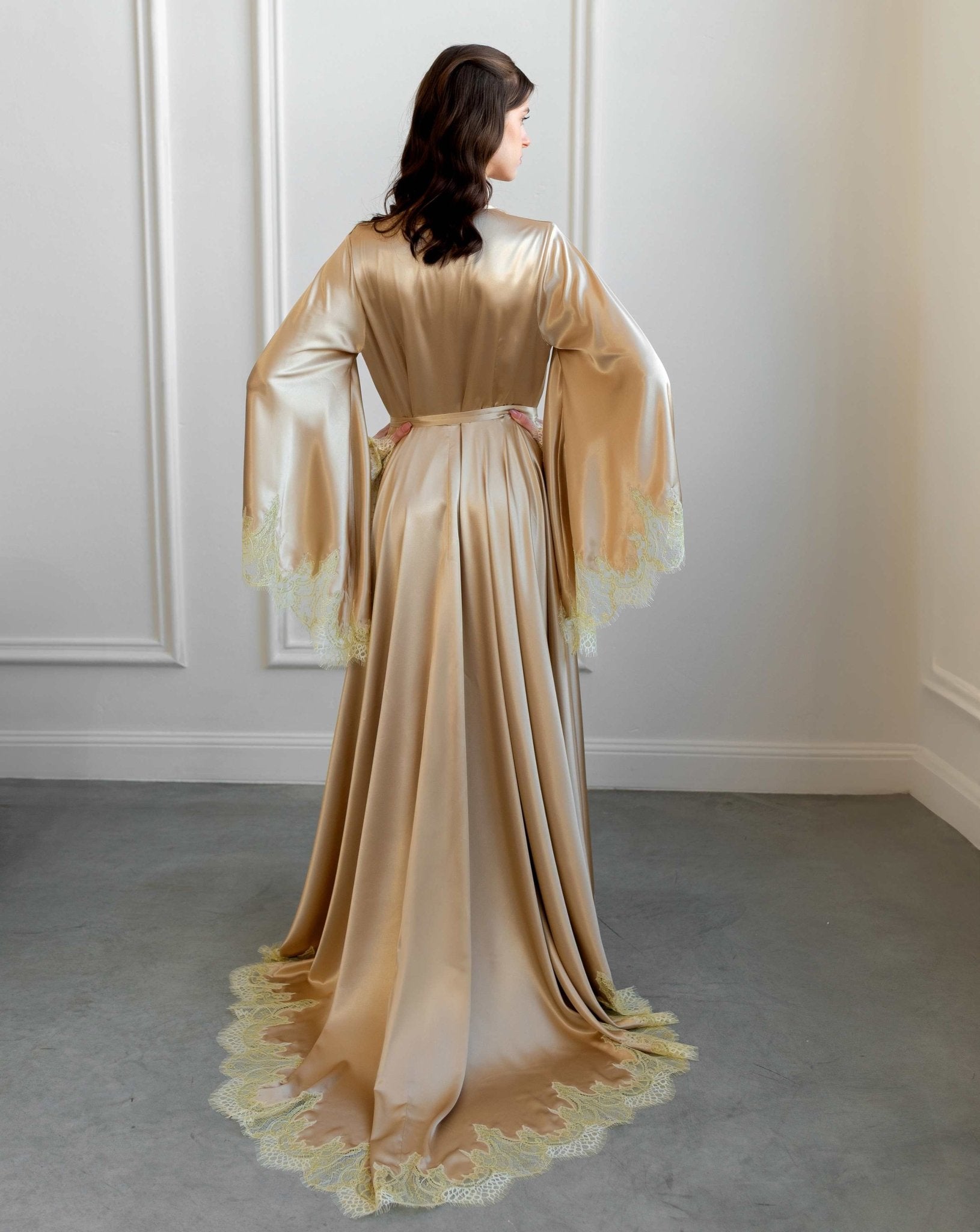Back view of the romantic lace nightgown with an elegant deep neckline and loose, airy sleeves.