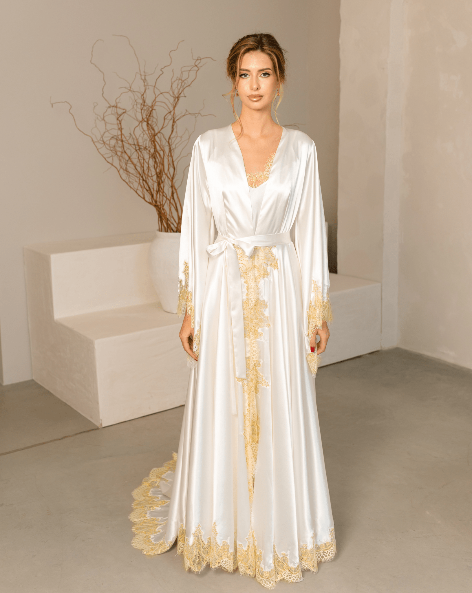 Full-length front view of the satin robe with lace accents, tied at the waist with a long flowing train.
