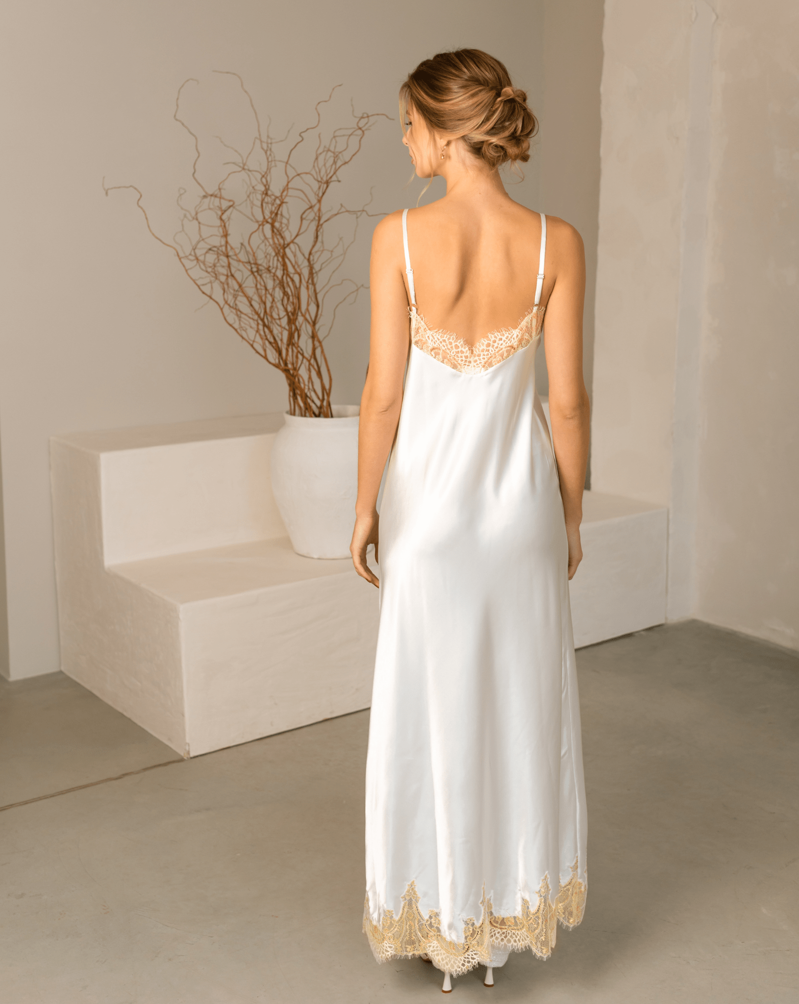Rear view of the nightgown from the Robe and Nightgown Set, showing the smooth fabric and lace hem.