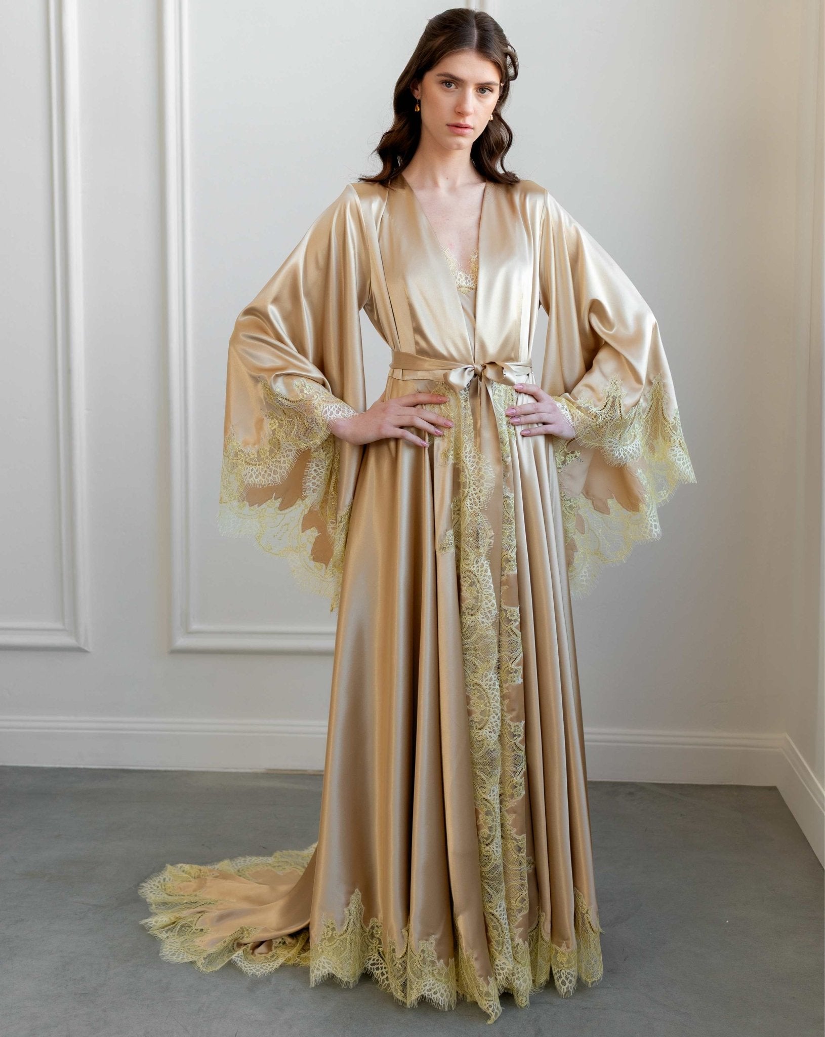 Long satin robe with a dramatic train and intricate lace embroidery on the wide sleeves.