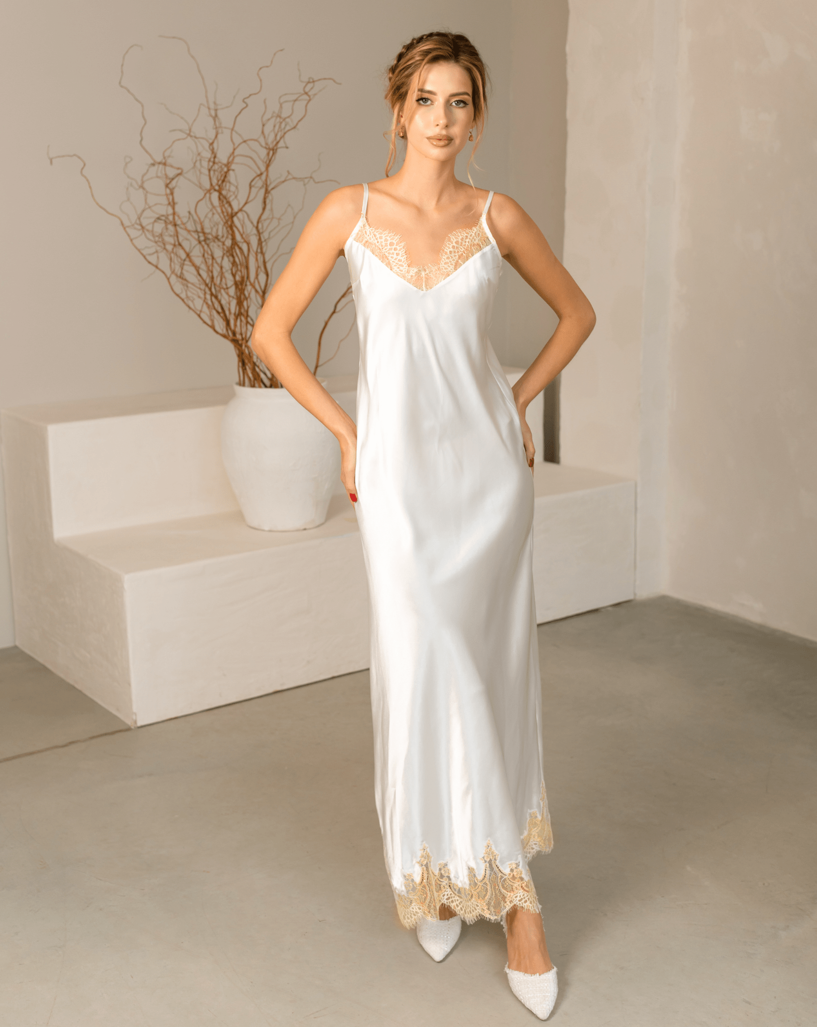 Elegant white Bridal Nightgown in delicate floral lace with wide butterfly sleeves and a long flowing skirt.