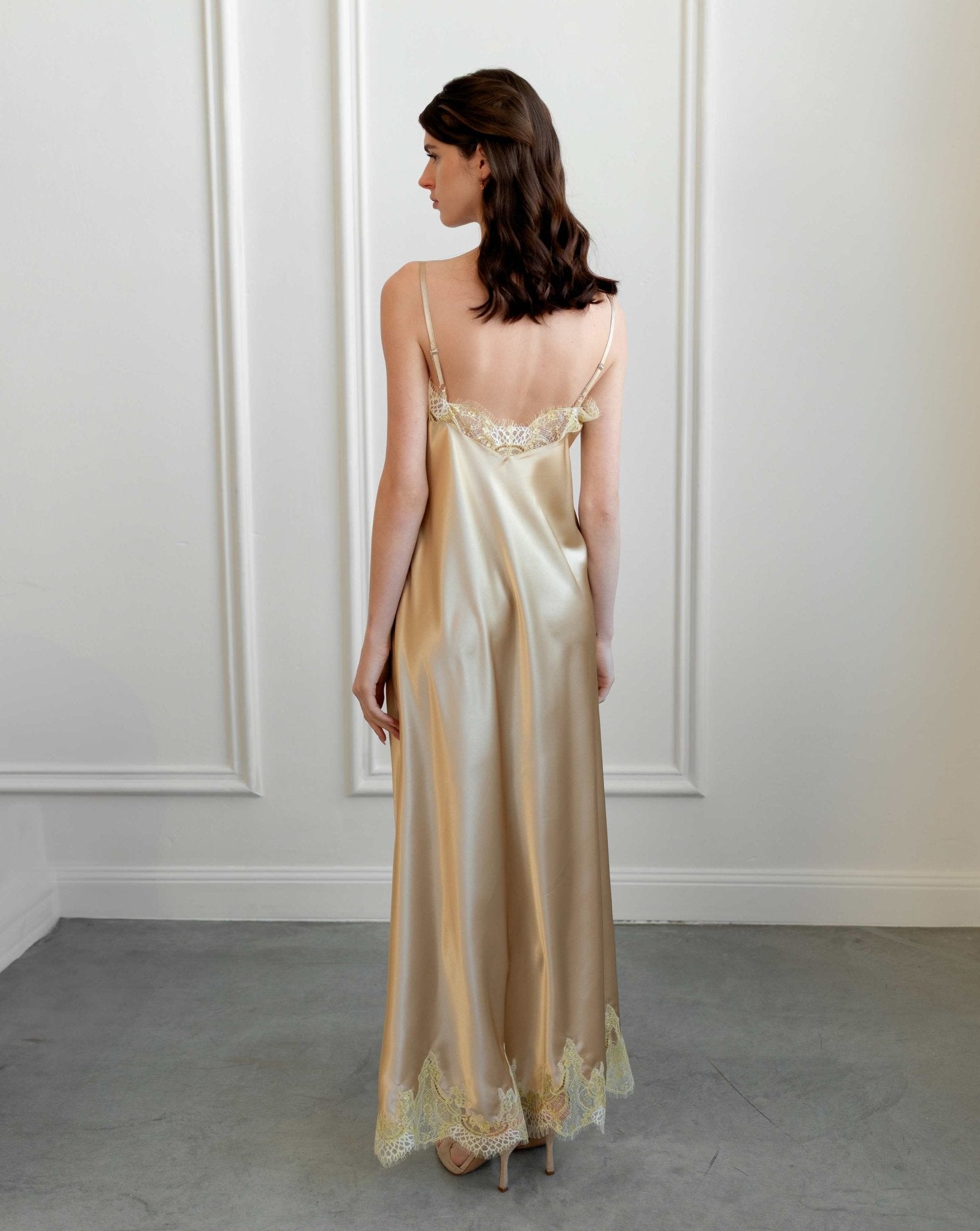 Back view of the satin nightgown featuring elegant lace trim and delicate thin shoulder straps.
