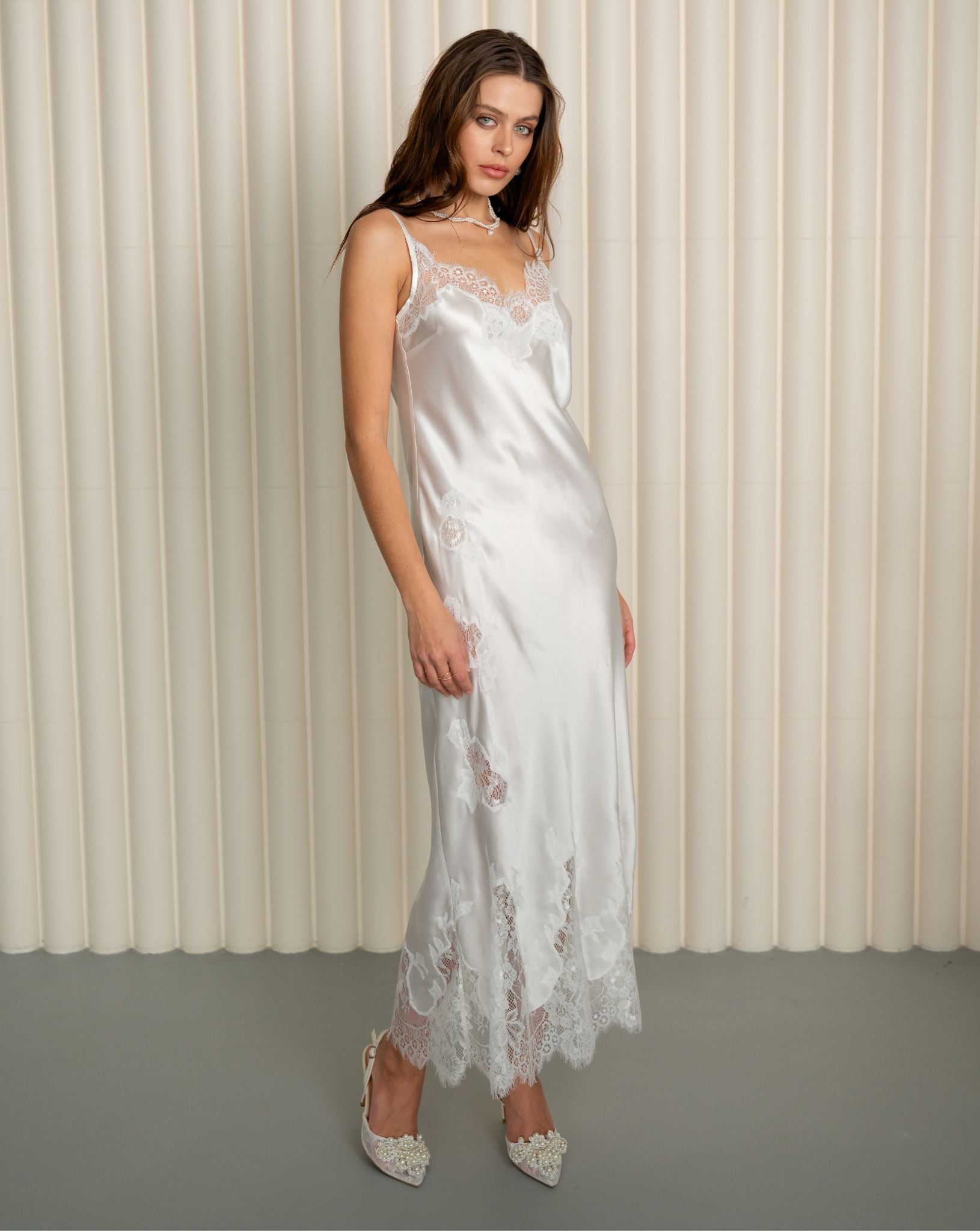 Model in white silk nightgown with lace details by Kafemme