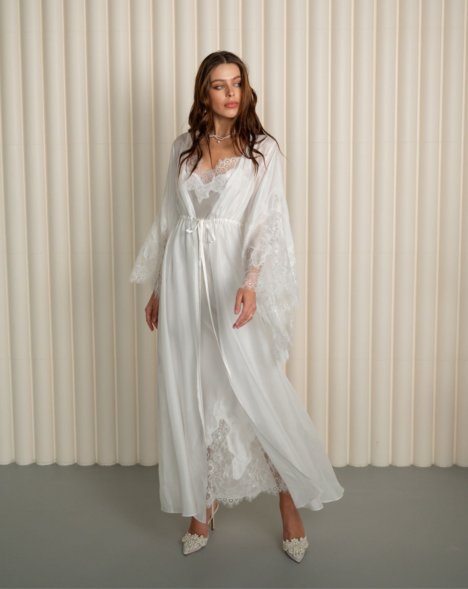 Woman wearing white silk robe over lace nightgown from Kafemme