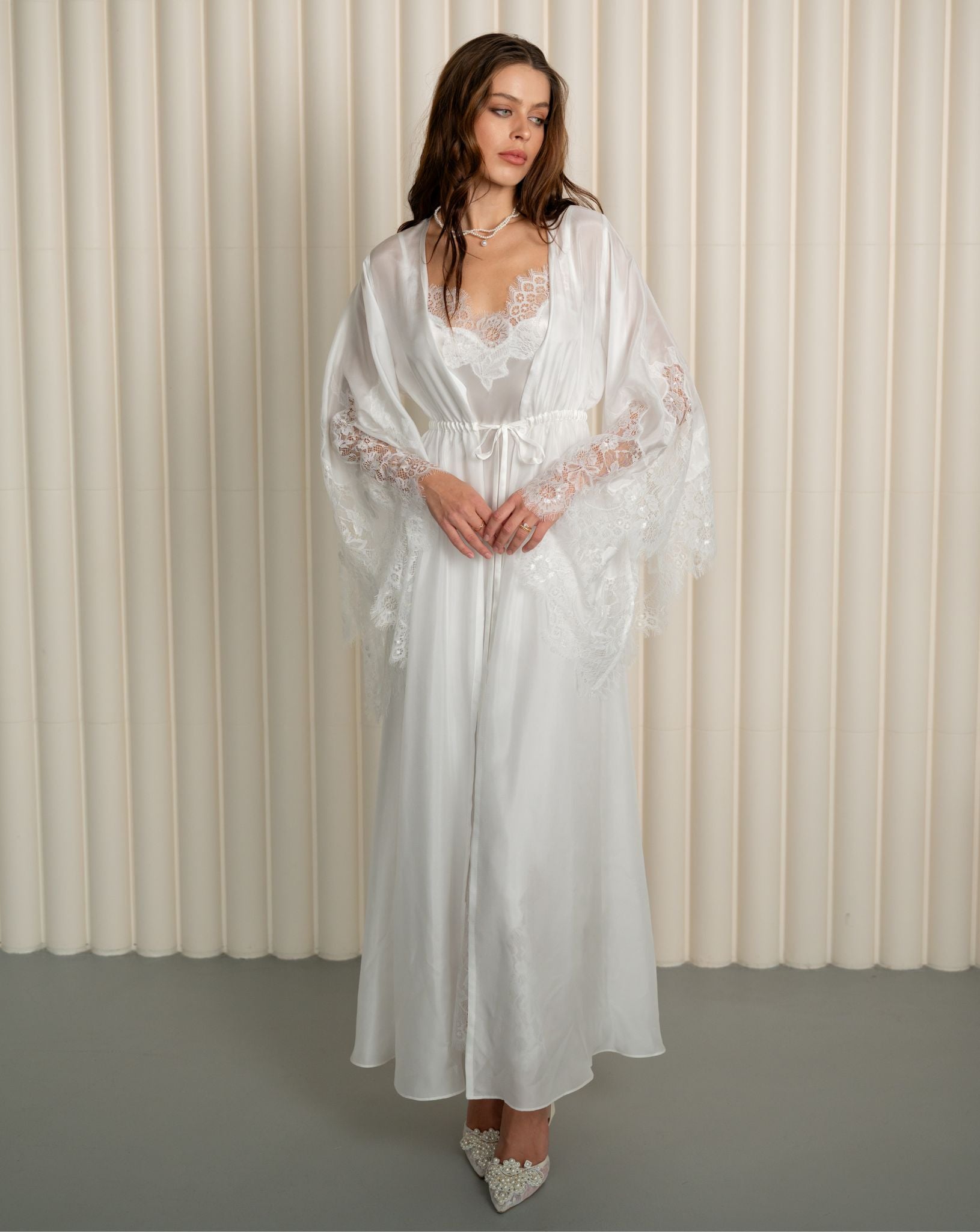 Woman in full-length white silk robe with lace by Kafemme