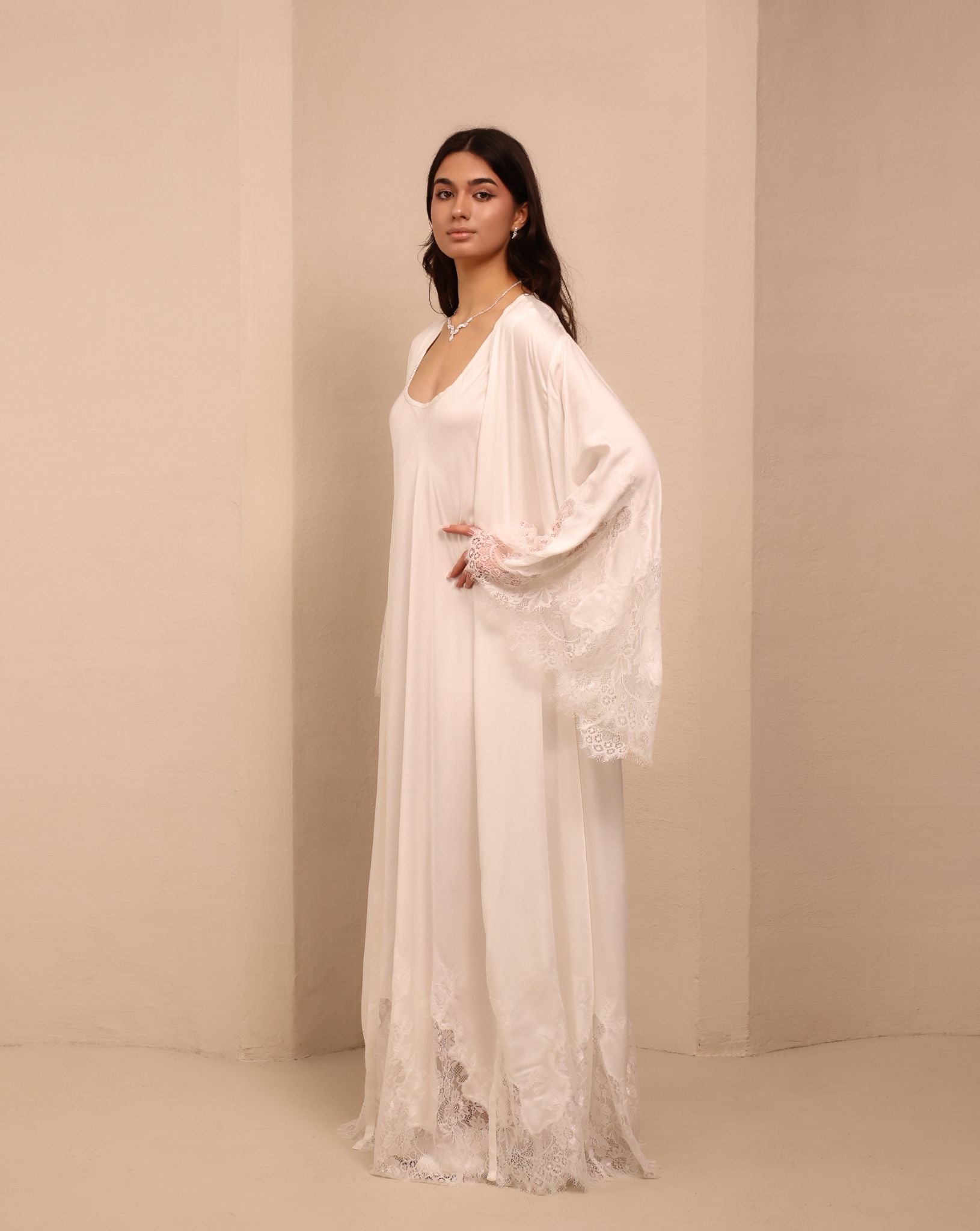 Side view of the white ensemble, highlighting the coordinating robe adorned with delicate lace trim on the sleeves.