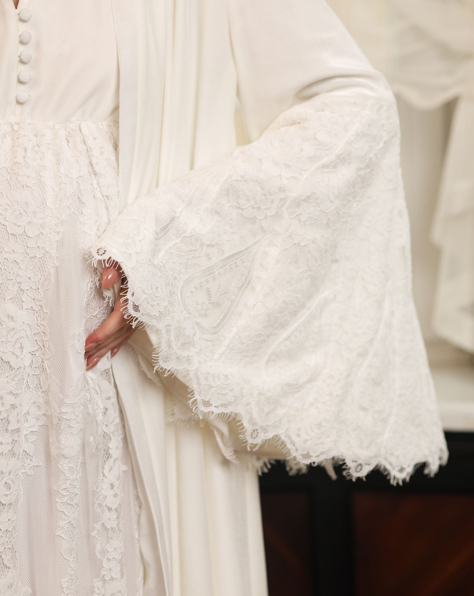 Detailed shot of the velvet sleeve, highlighting the exquisite lace work and the soft texture of the material.