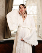 A pose featuring the tied robe with a focus on bell sleeves adorned with French lace trim.