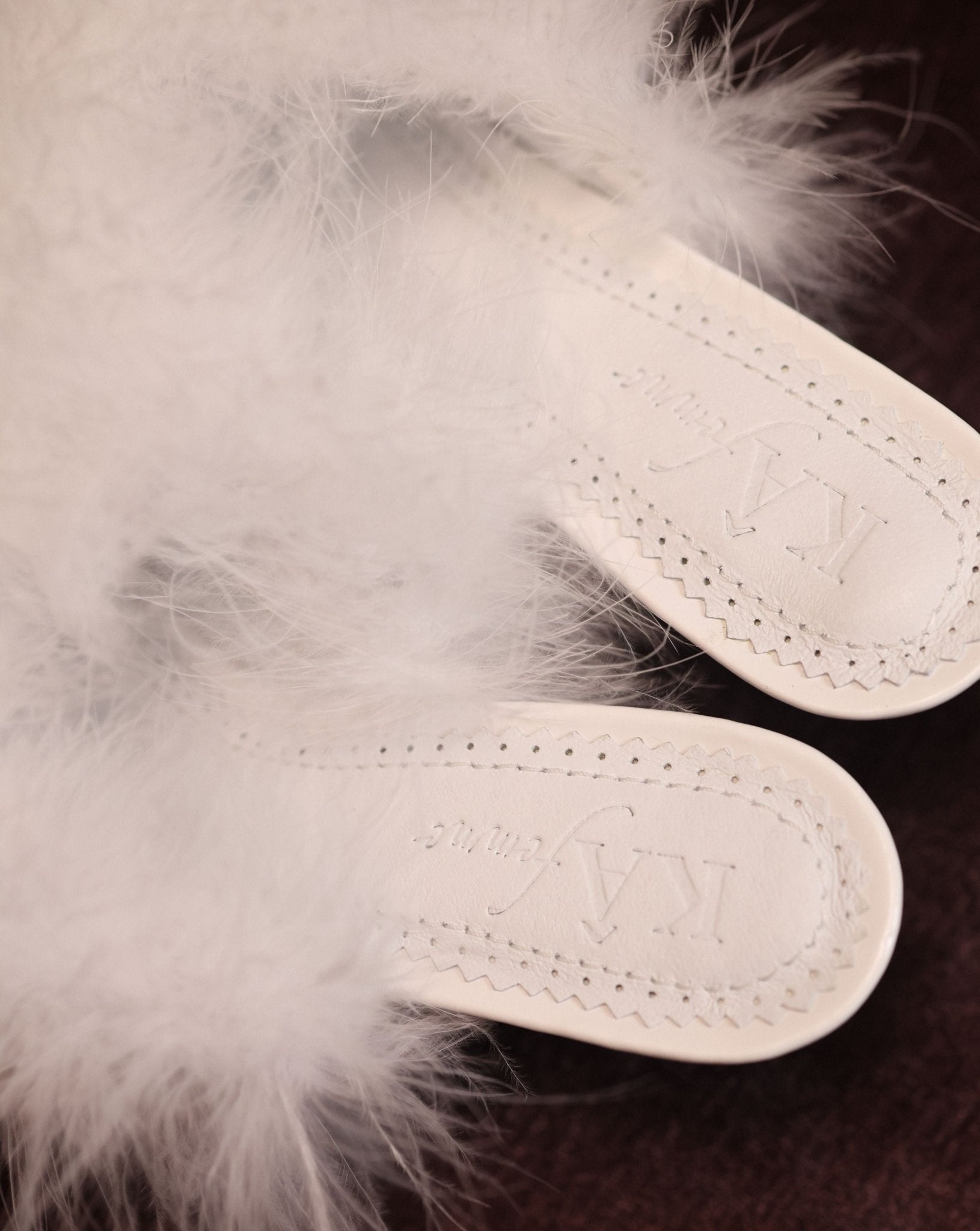 Close-up of the genuine leather insole with soft padding and the brand logo for a sense of quiet luxury.