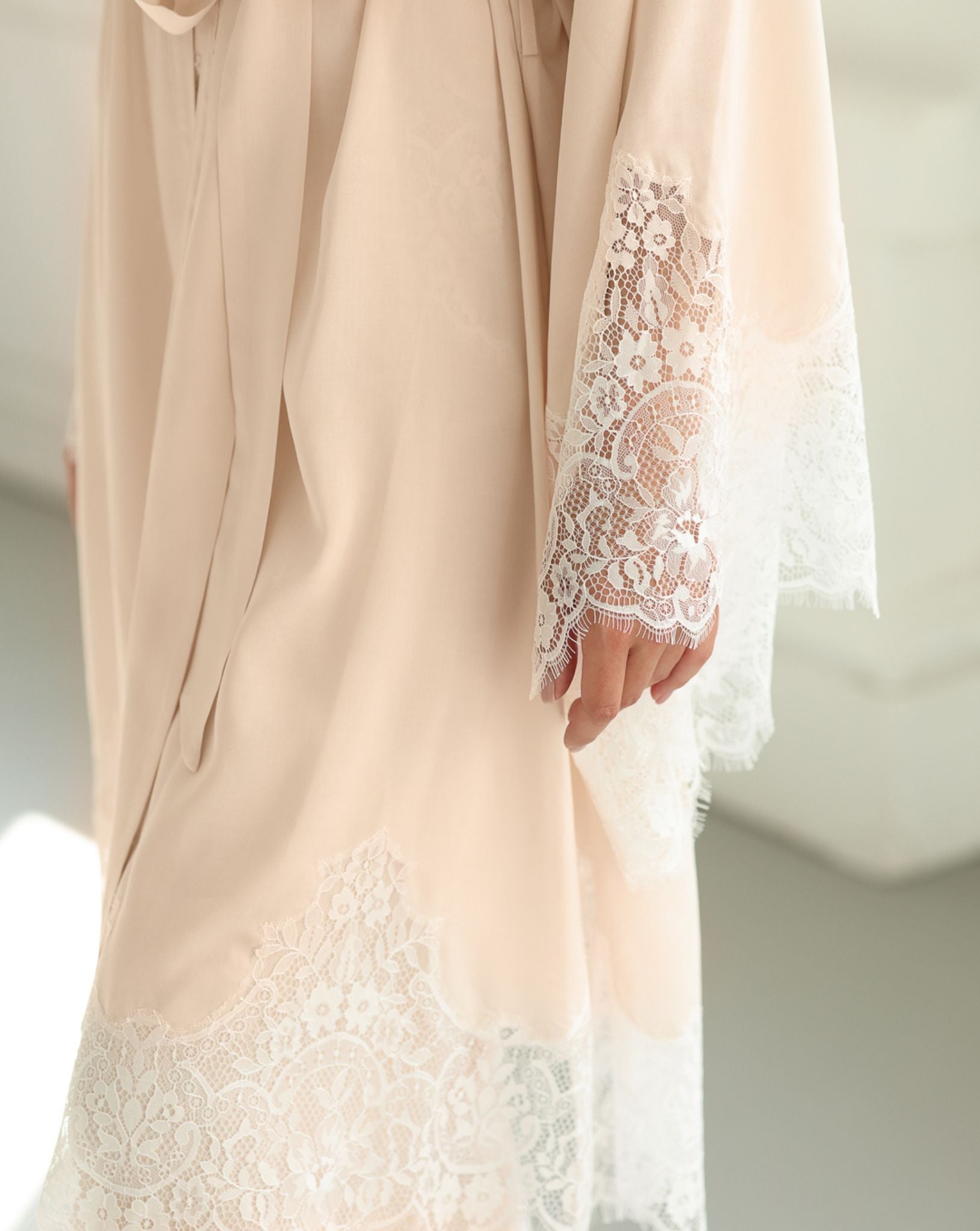 Close-up of the robe's lace-trimmed sleeves and texture, illustrating the gentle feel of the premium cotton blend.