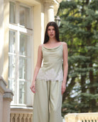 A nearly full-length shot of the tank top and trousers, highlighting the lace-trimmed hem and elastic waistband.