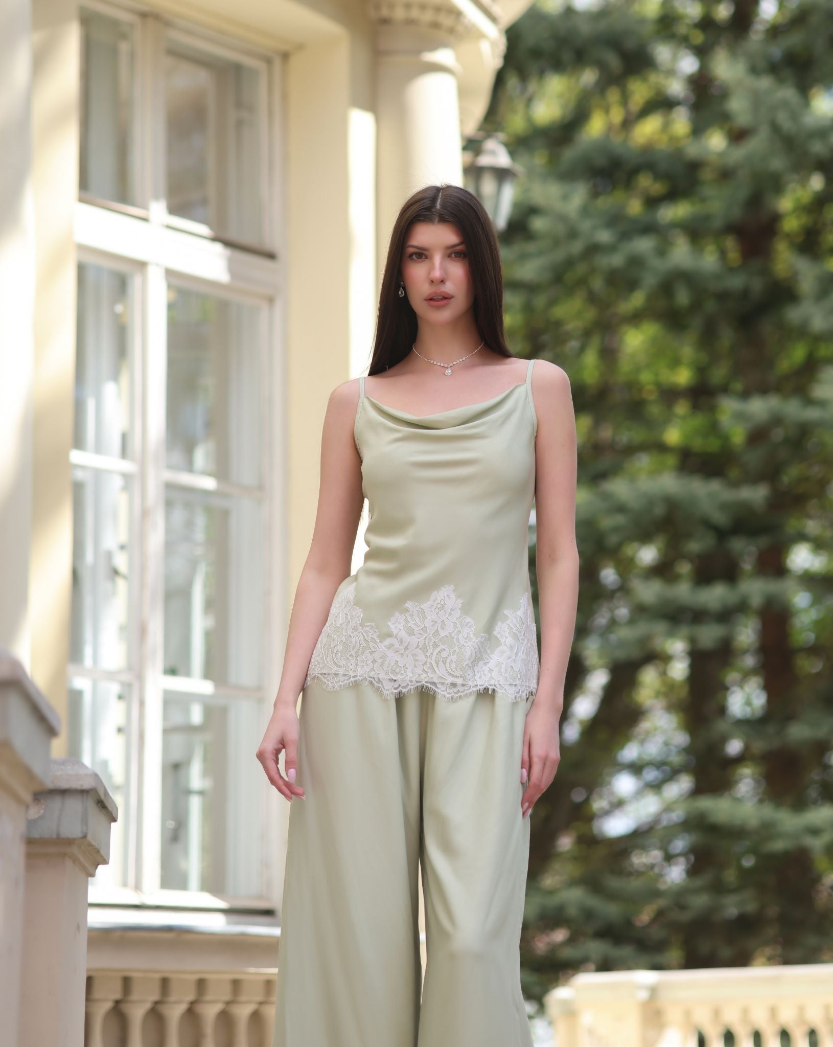 A nearly full-length shot of the tank top and trousers, highlighting the lace-trimmed hem and elastic waistband.
