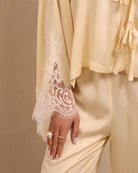 Close-up of the sleeves, featuring subtle lace detailing that adds a light, feminine contrast to the top.