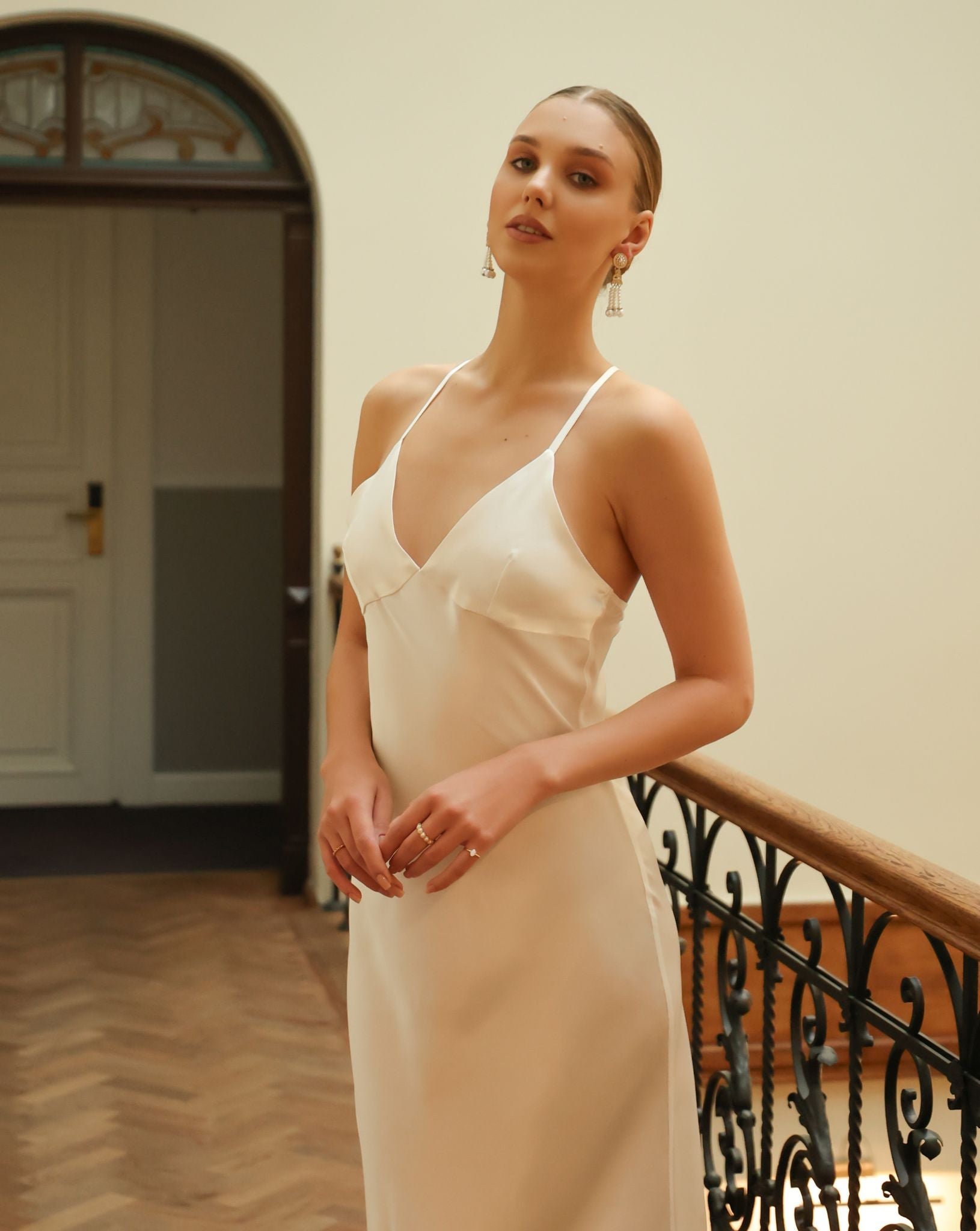 Front view of a white silk satin nightgown, showcasing its structured fit, radiant glow, and graceful silhouette.