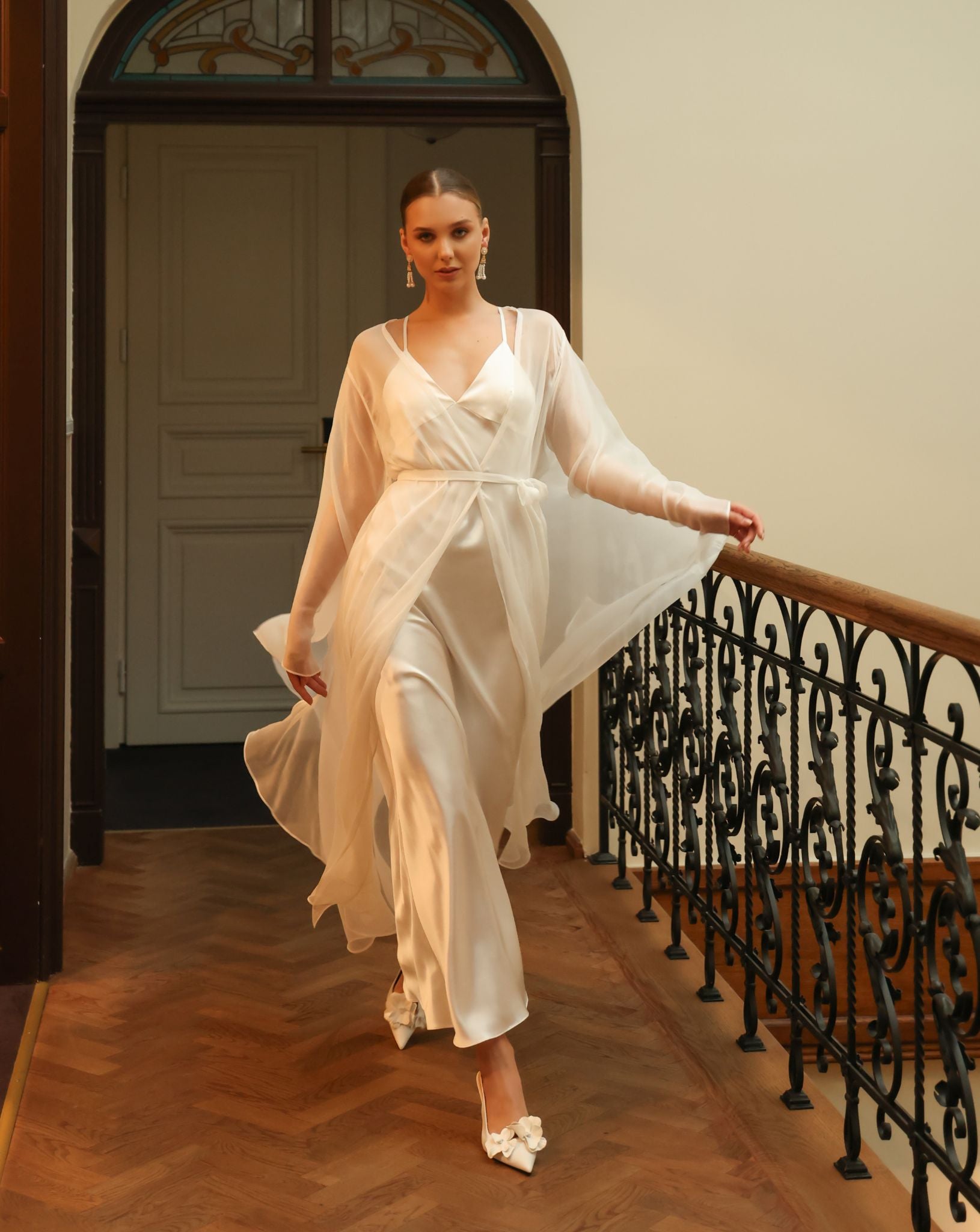 Elegant Silk Robe and Nightgown Set in motion along a corridor, showing the effortless glide of the premium fabric.