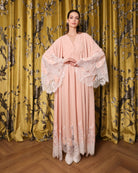 A static shot focusing on the wide sleeves decorated with lace at the ends for a soft, feminine touch.