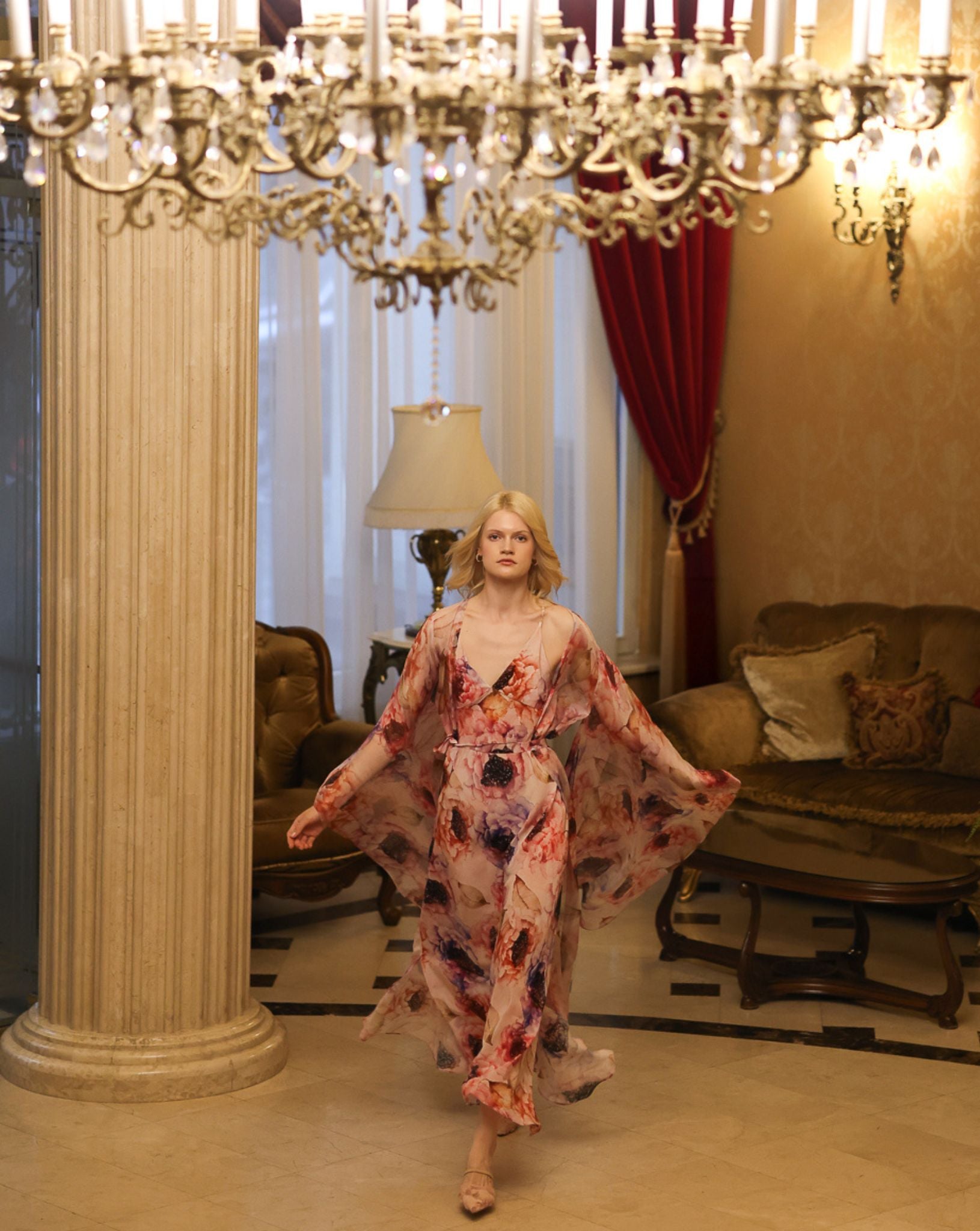 Graceful walk through a hall in a flowing silk garment, showing the effortless movement of high-quality fabrics.