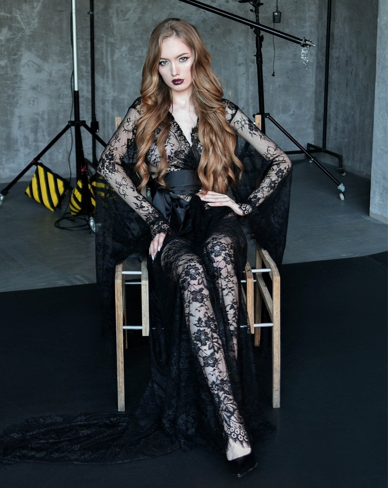 Black floral lace robe styled while seated on a wooden chair